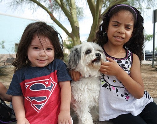 Two young children with a dog
