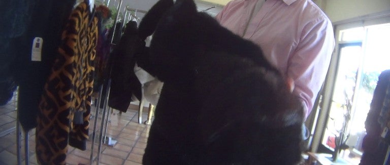 A person holds a fur coat