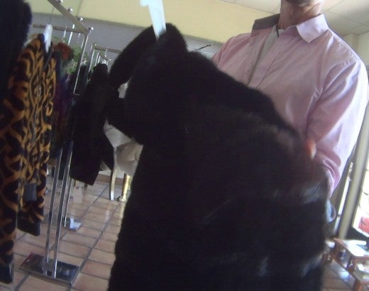 A person holds a fur coat