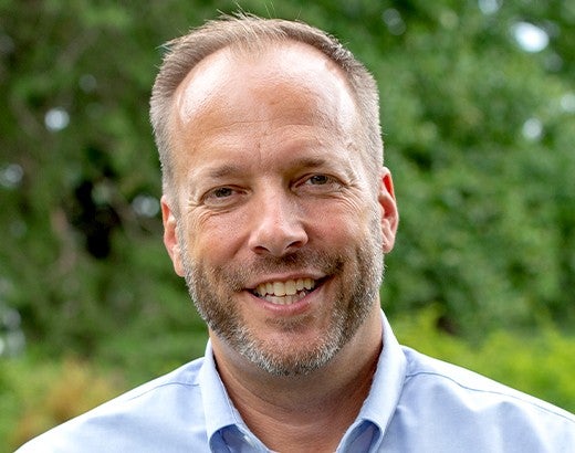 Headshot of a man, Jeff, smiling at the camera