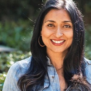 Headshot of a woman smiling at the camera while outside