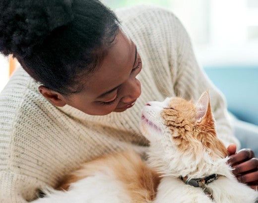 Woman cuddling with her cat