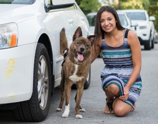 Johanie and Rambo standing near their vehicle