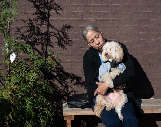 Woman holding a dog outside
