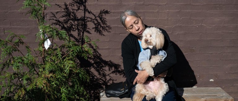 Woman holding a dog outside