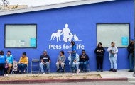 People waiting in line outside for Pets For Life services.