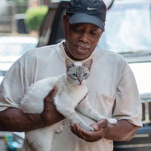 Man holding his white cat