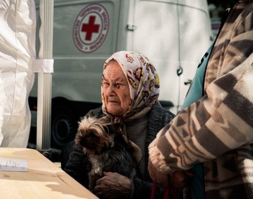 A woman receives aid for her dog