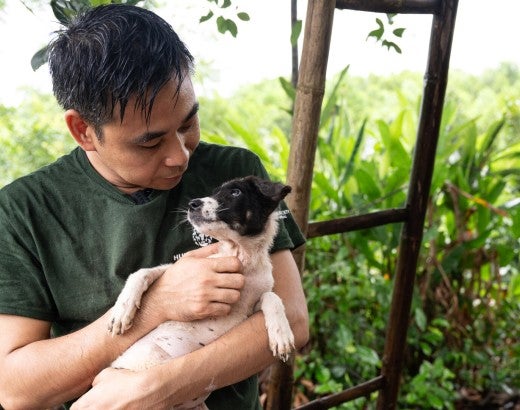A man holding a dog