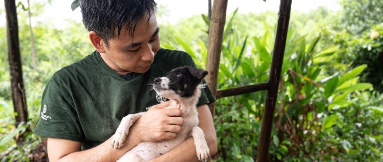 A man holding a dog